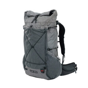Grey hiking backpack with front bungee cord and side pockets, viewed from the side of a standing bag